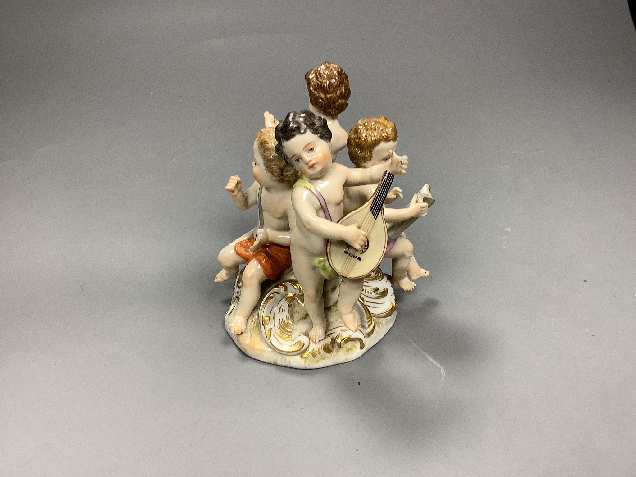 A Meissen group of four putti musicians, late 19th century, 11cm high, losses